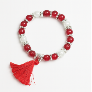Pulsera elastica con perlas y borla de pelo varios colores